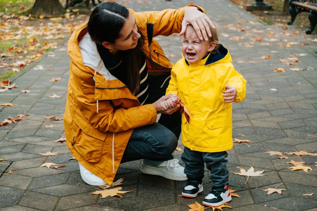 Parent comforting crying toddler